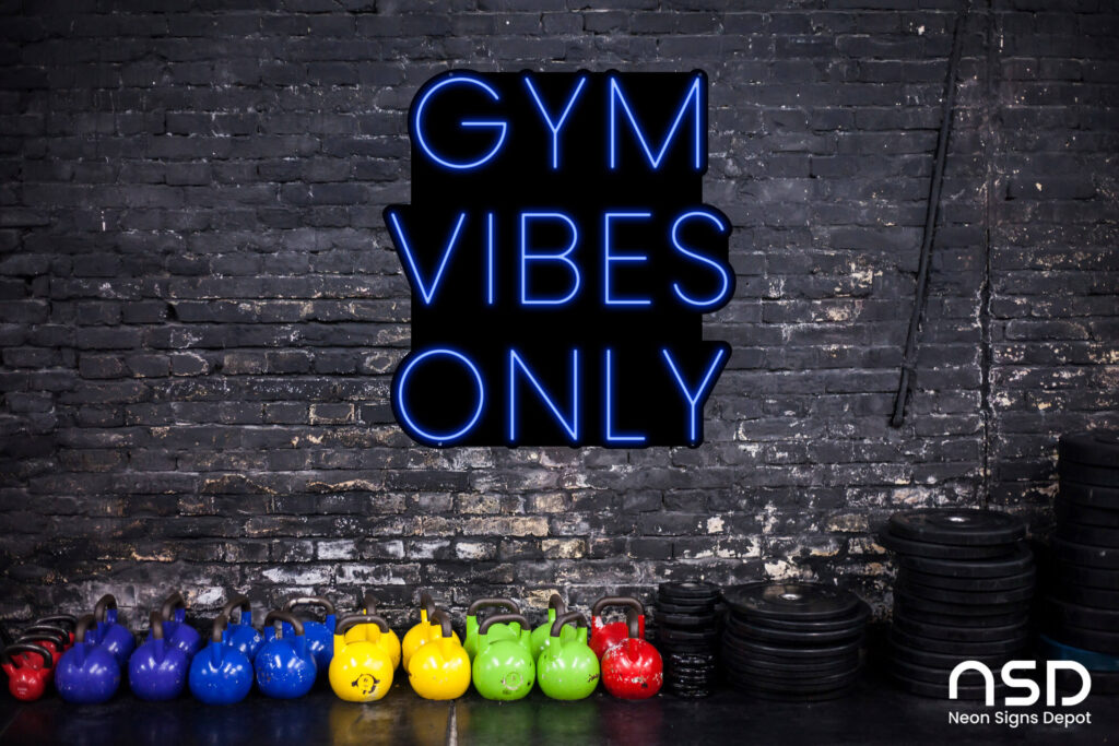 Bright motivational neon sign glowing on a gym wall